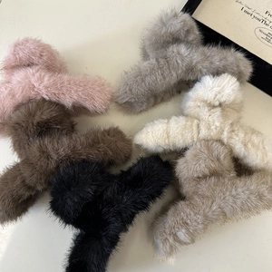 Elegant oversized plush hair claws in multiple colors including pink, grey, and beige