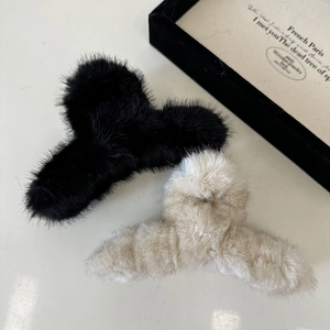Fuzzy plush shark claw clips in black and cream beige for elegant winter hairstyles