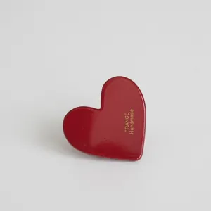 Glossy red heart-shaped hair clip featuring golden FRANCE Handmade lettering logo