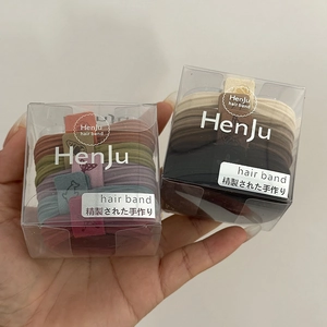 Close-up of two boxes of high elasticity hair bands in Morandi and earth tone colors