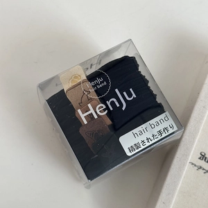 Detail of high-elasticity hair bands in a transparent box with minimalist design