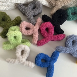 Macro view of plush cross hair claws in multiple colors with fuzzy velvet texture