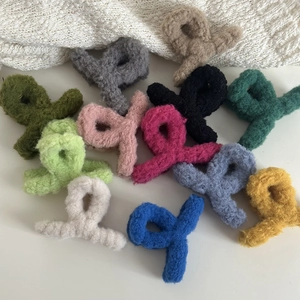 Close-up of soft faux fur hair claw clips in various elegant colors for autumn and winter style