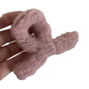 Fuzzy plush crisscross hair claw clip in lotus root pink with soft fleece texture