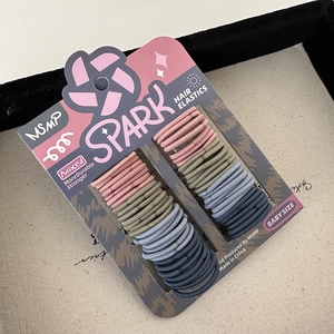 Detail of durable high-elastic baby hair ties in pastel colors on a product card