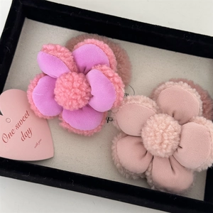 Gros plan sur des élastiques à fleurs en peluche avec pétales 3D et textures douces