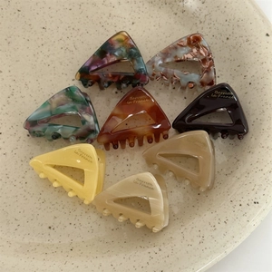 Set of eight acetate triangle hair claws with various marble and tortoise patterns