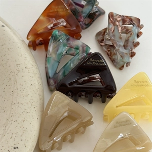 French style acetate triangle hair claws set in multiple colors with gold lettering
