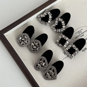 Detail view of black velvet hair clips with sparkling rhinestones in various shapes