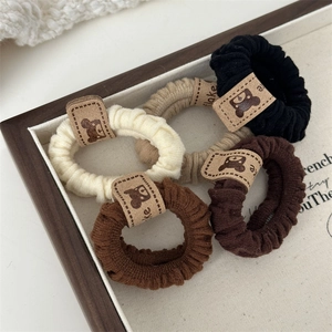 Set of 4 elastic hair scrunchies with cute bear tags in brown and cream colors