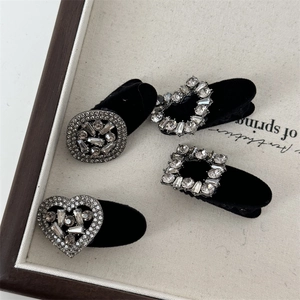 Set of four black velvet hair clips with sparkling rhinestones in geometric shapes