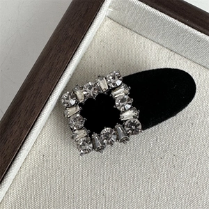 Detail of square crystal rhinestone hair clip with black velvet base for women