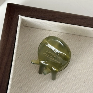 Detailopname van olijfgroene acetaat mini haarklem met gouden France Handmade logo