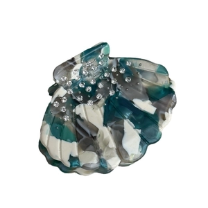 Artistic shell-shaped acetate hair claw with blue marble texture and crystal rhinestones