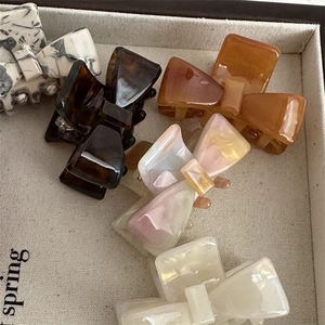Sweet acetate bow hair claws set in marble, tortoiseshell, and pearl white colors
