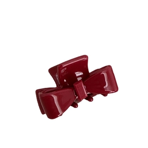 Polished wine red bow hair claw clip in high-gloss acetate for elegant hairstyles