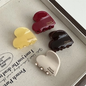 Chic heart-shaped acetate hair claws in four colors with elegant glossy finish