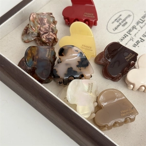 Close-up of heart-shaped acetate hair clips with France Handmade gold lettering detail