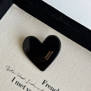 Handmade black acrylic heart hair clip with gold France lettering and glossy finish