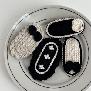 Handmade crochet hair clip set with black and beige yarn patterns and pearl accents