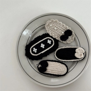 Set of four handmade black and white crochet hair clips with pearls and bows