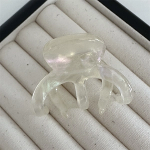 Macro view of pearlescent white acetate hair claw clip with colorful iridescent finish