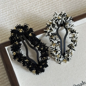 Elegant French style tweed hair clips with gold thread detail on wooden tray