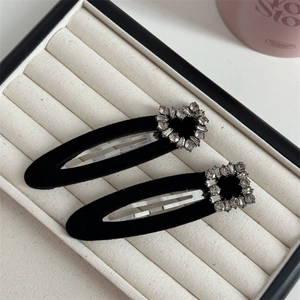 Detail of black velvet hair clips with heart and square rhinestone embellishments