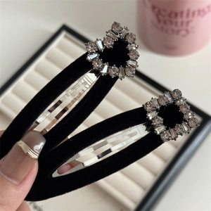 Detail of black velvet BB clips with heart and square rhinestone embellishments