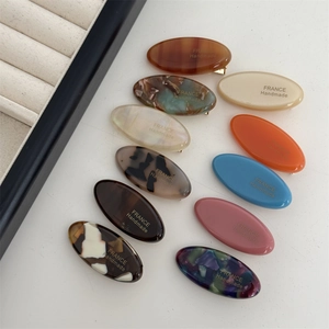 Set of 10 oval acetate hair clips with marble texture and gold lettering