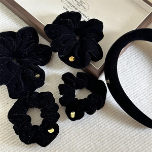 Five-piece set of black velvet hair accessories including scrunchies and a padded headband