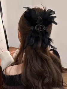 Elegant large black ostrich feather hair claw clip shown on a woman half-up hairstyle
