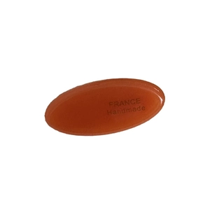 Amber acetate oval hair clip with gold label and France Handmade text on white background