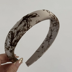 Detail of grey Toile de Jouy floral fabric texture on thick padded sponge headband
