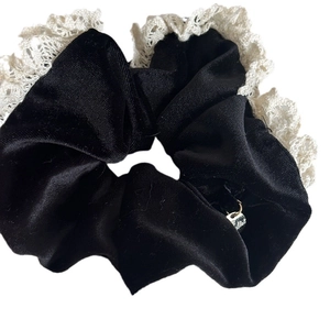 Elegant black velvet scrunchie with white lace trim and metal charm for women