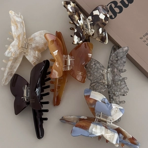 Set of six butterfly acetate hair claws in various vintage patterns and marble textures