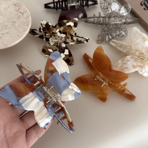 Detail of marble pattern acetate butterfly hair claws with durable metal springs