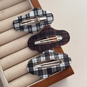 Three-piece set of checkered BB hair clips in black, white, and coffee patterns on a tray