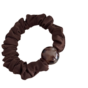 Deep brown leopard scrunchie with a large marbled resin bead for stylish hairstyles