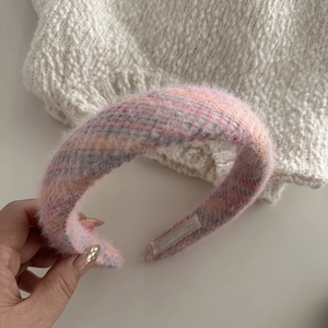 Close-up of pink knit fuzzy headband with thick faux fur texture and non-slip inner grip