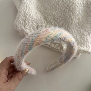 Macro shot of colorful striped faux mink fur headband with soft plush texture details