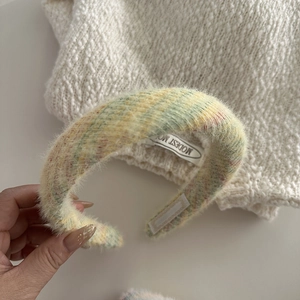 Close-up of soft knit plaid headband with colorful fluffy faux mink fur texture