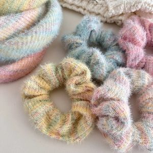 Close-up of soft winter fuzzy hair ties in colorful pastel macaron knit textures