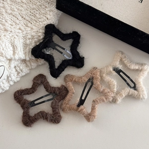 Detail view of plush knit star hair clips in black, brown, khaki, and beige colors