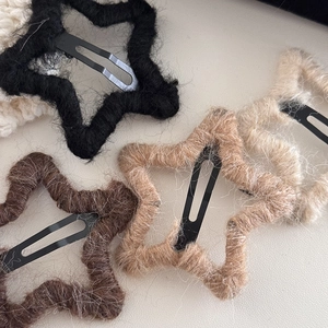 Star-shaped handmade knit hair clips in warm earthy colors with velvet texture