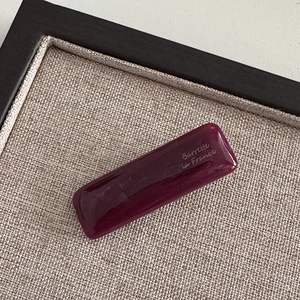 Detail of plum resin rectangular hair clip with gold Barrette La France lettering