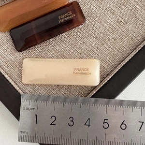Rectangle tortoise shell acetate hair clips in brown and cream on a linen tray