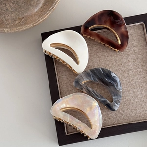 Elegant acetate hair claws set in leopard print and marble patterns with gold metal base