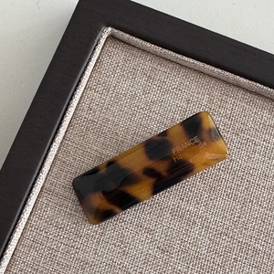 Close-up of a tortoiseshell acetate hair clip with FRANCE Handmade gold lettering