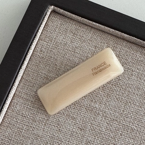 Macro shot of rectangular acetate hair clip with golden France Handmade lettering